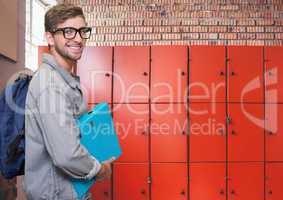 male student holding folder in front of lockers