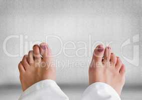 Bare feet and grey stone background