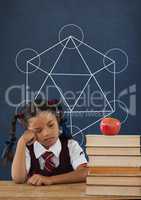 Sad student girl at table against blue blackboard with school and education graphic