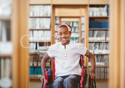 Disabled boy in wheelchair in school library