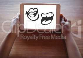 Mouth cartoons on tablet in hands