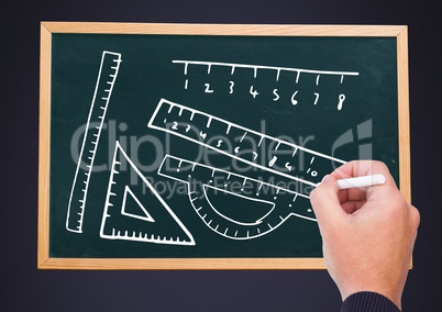 Hand drawing rulers on blackboard