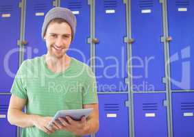 male student holding tablet in front of lockers
