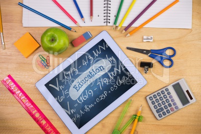 Tablet on a school table with school icons on screen