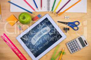 Tablet on a school table with school icons on screen