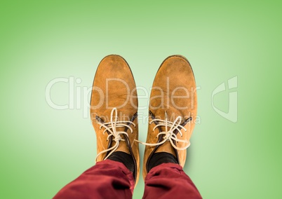 Brown shoes on feet with green background