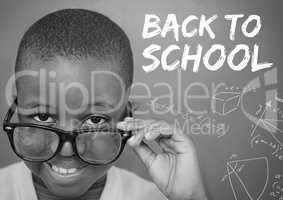 Back to school text on blackboard with boy