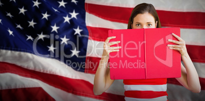 Composite image of student holding book over face