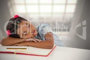 Composite image of girl napping on book at desk