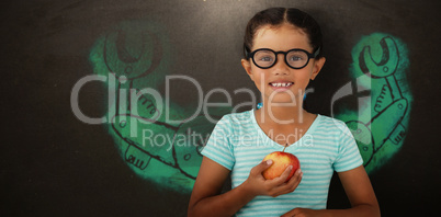 Composite image of portrait of smiling girl wearing eyeglasses holding apple