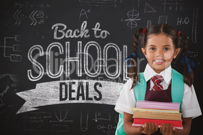 Composite image of smiling schoolgirl carrying books