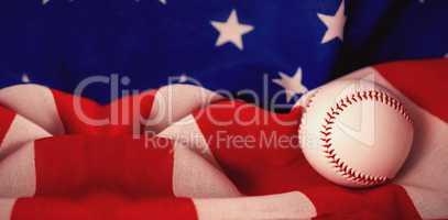 Baseball ball on crumbled national flag