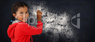 Composite image of portrait of smiling girl holding chalk