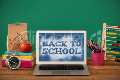 Composite image of back to school text on green and blue splash