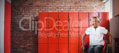 Composite image of girl sitting in wheelchair in school corridor