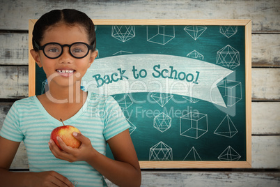 Composite image of portrait of smiling girl wearing eyeglasses holding apple