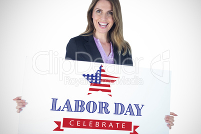 Composite image of beautiful businesswoman holding blank billboard over white background