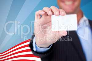 Composite image of businessman holding blank card against white background