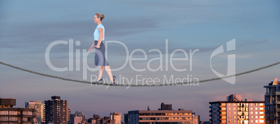 Composite image of businesswoman walking