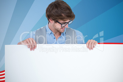 Composite image of handsome man holding blank panel