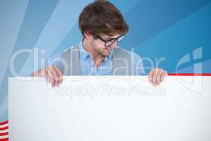Composite image of handsome man holding blank panel