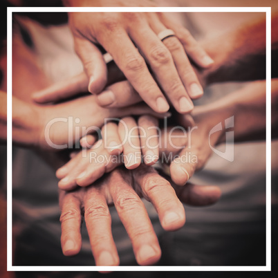 Happy volunteer family putting their hands together