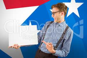 Composite image of geeky hipster showing a card
