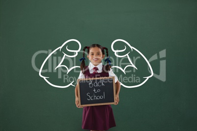 Happy student girl with fists graphic holding a little blackboard against green blackboard