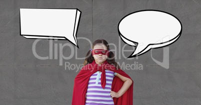 Girl as a super heroine with speech bubble standing against grey background