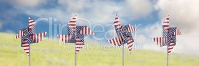 USA wind catchers in front of sky and grass