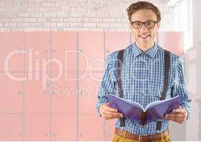 male student holding book in front of lockers