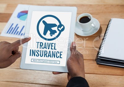Person using a tablet with travel insurance concept on screen