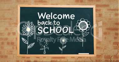 Welcome back to school text and flowers  on blackboard
