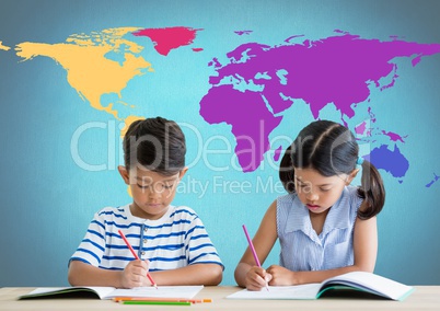 School kids writing at desk in front of colorful world map