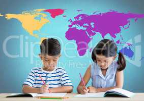 School kids writing at desk in front of colorful world map
