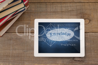 Tablet on a school table with school icons on screen