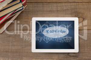 Tablet on a school table with school icons on screen