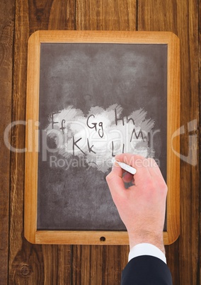 Hand writing letters on blackboard