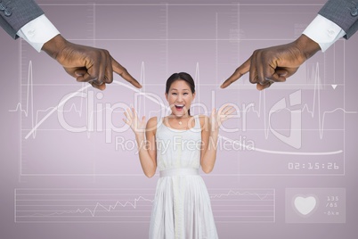 Hands pointing at surprised business woman against pink background with electrocardiogram