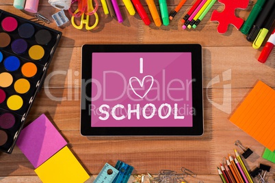 Tablet on a school table with school icons on screen