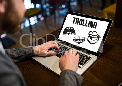 Trolling text and cartoon mouth graphics on laptop with hands