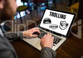 Trolling text and cartoon mouth graphics on laptop with hands