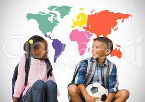 Kids sitting in front of colorful world map with football