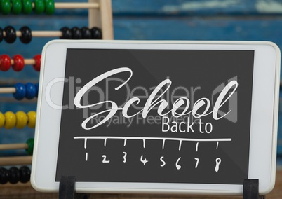 Tablet on a school table with back to school text on screen