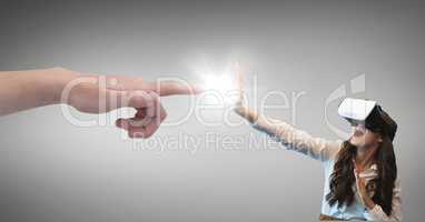 Hand pointing at surprised woman in VR headset against grey background