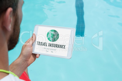 Man holding a tablet with travel insurance concept on screen