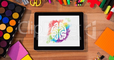 Tablet on a school table with colored brain on screen