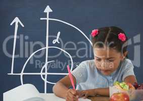Student girl at table writing against blue blackboard with school and education graphic