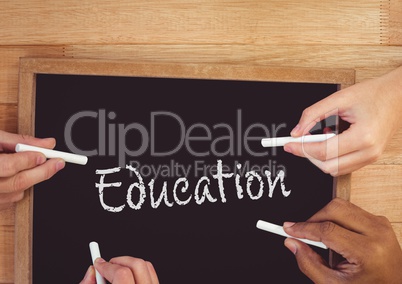 Hands writing education on blackboard