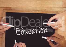 Hands writing education on blackboard